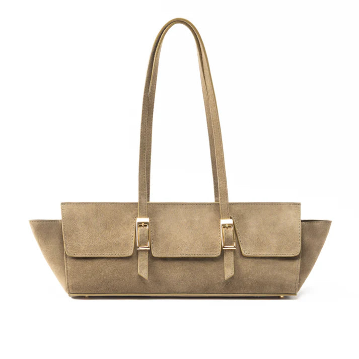 A taupe-brown suede tote bag with long shoulder straps and gold-tone buckle hardware, shown against a plain white background.