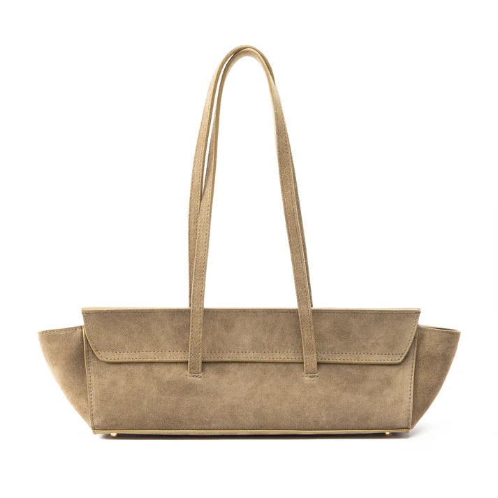 A taupe suede tote bag with long shoulder straps and a structured, wide body, shown against a plain white background.