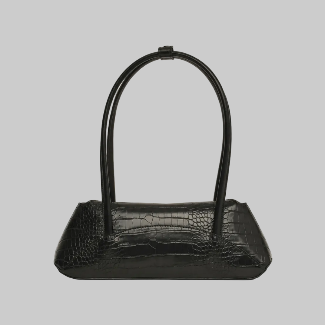 A black crocodile-embossed leather handbag with a unique double-loop top handle, shown against a neutral light gray background.