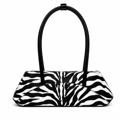 A black and white zebra-print handbag with a structured shape and two curved black shoulder straps, shown against a plain white background.